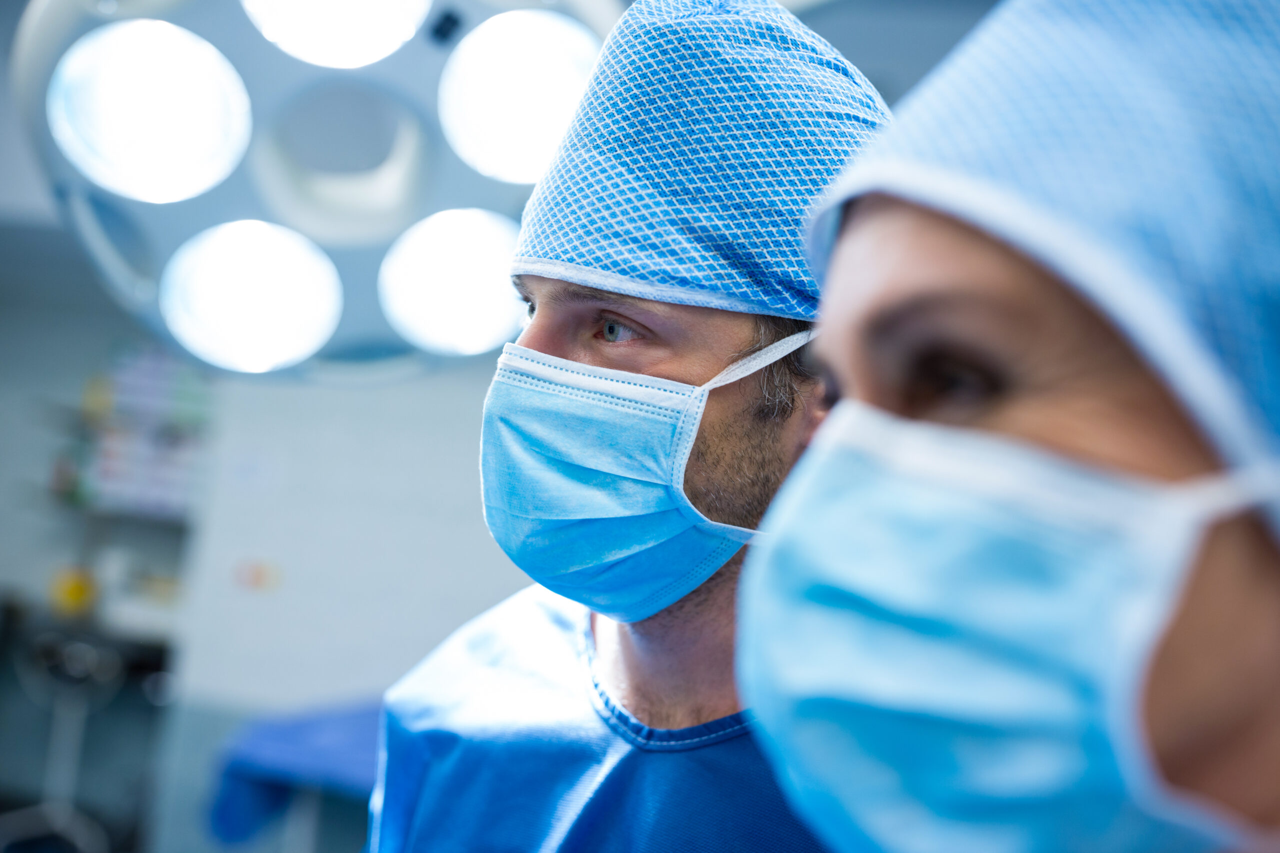 Surgeons standing in operation room at hospital