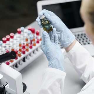 female-researcher-laboratory-with-test-tubes-vaccine-bottle female-researcher-laboratory-with-test-tubes-vaccine-bottle