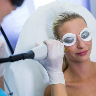 Woman receiving laser epilation treatment on her face at beauty salon Woman receiving laser epilation treatment on her face at beauty salon